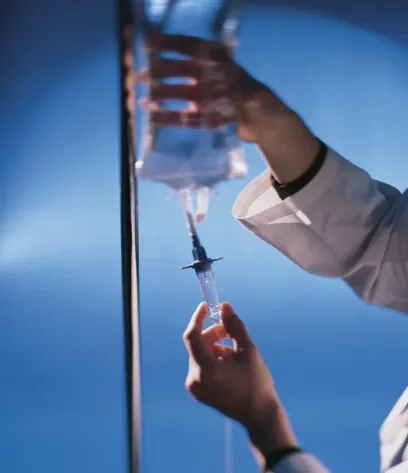 Clinician preparing an intravenous drip line