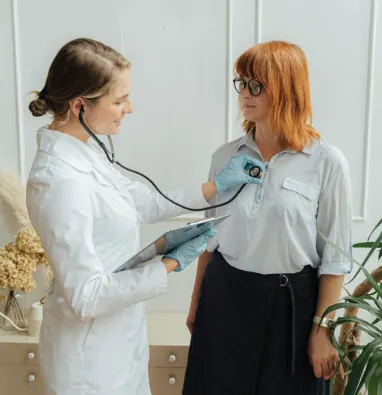 A clinician checking a patient's blood pressure