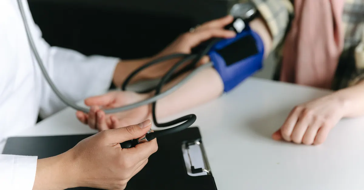 Clinician measuring a patient's blood pressure during a treatment review